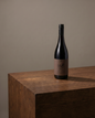 Bottle of Funk 108 Shiraz standing on a wooden plinth against a warm neutral backdrop
