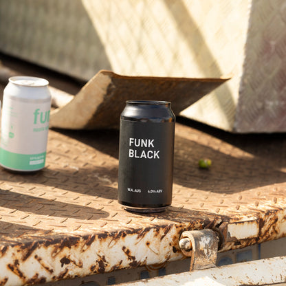 A can of Funk Black on a weathered ute tray with the rest of the Funk range behind